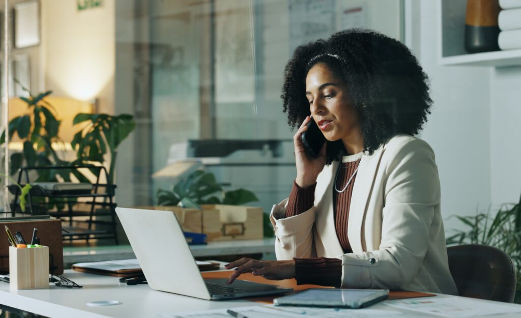 woman talking on the phone and working on the computer