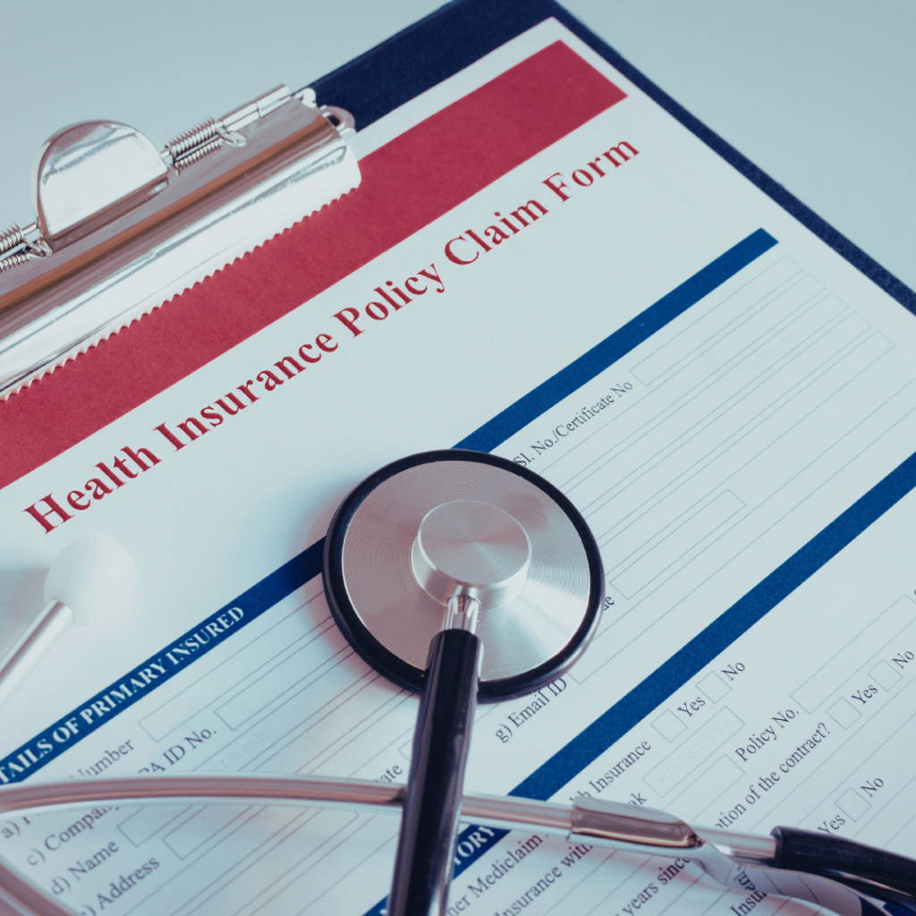 a stethoscope sitting on insurance papers